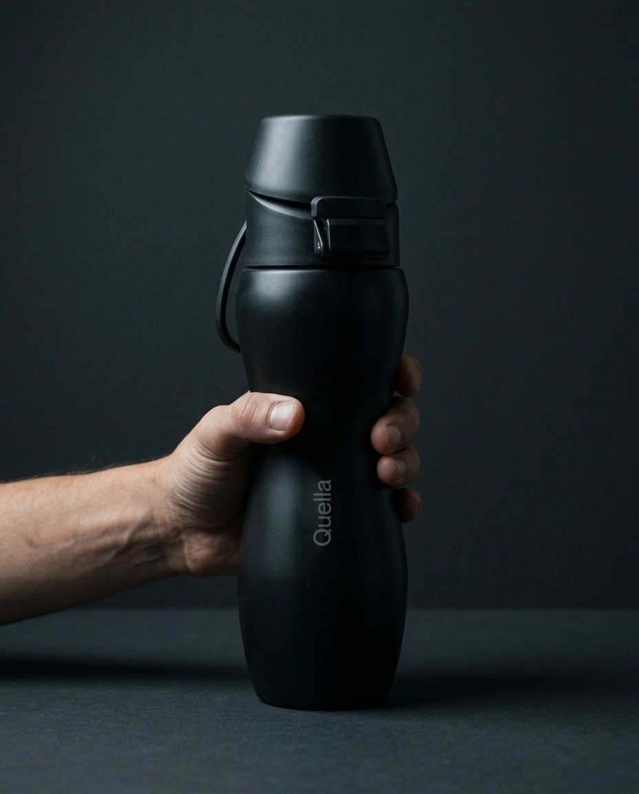 Quella double hourglass bottle held in a hand